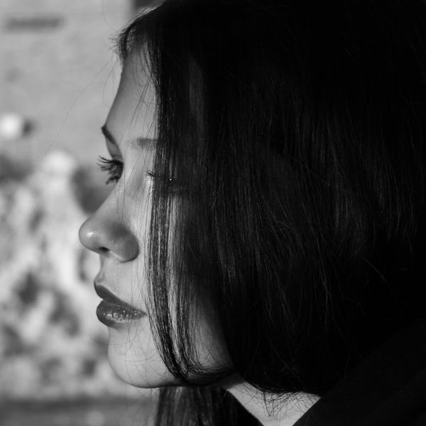 Close-up of a person focusing on a distant point.